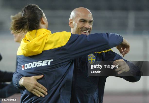 Zlatan Ibrahimovic of the Sweden football team hugs teammate Daniel Majstorovic during a practice session on the eve of the UEFA Euro 2012 Group E...