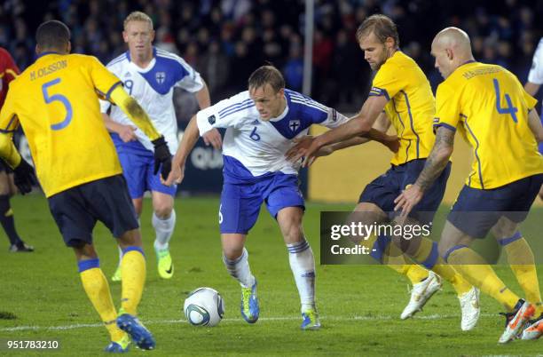 Finland's Mika Väyrynen controlls the ball in between Sweden's Martin Olsson , Olof Mellberg and Daniel Majstorovic during the UEFA Euro 2012 Group E...