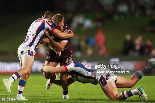 Jake Trbojevic of the Sea Eagles is tackled during the Round eight NRL match between the Manly-Warringah Sea Eagles and the Newcastle Knights at...