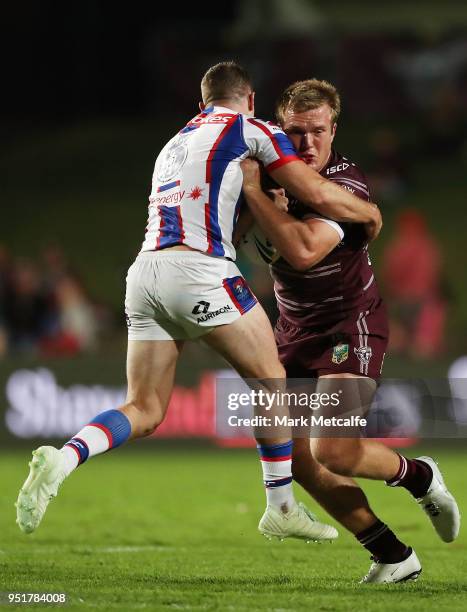 Jake Trbojevic of the Sea Eagles is tackled during the Round eight NRL match between the Manly-Warringah Sea Eagles and the Newcastle Knights at...