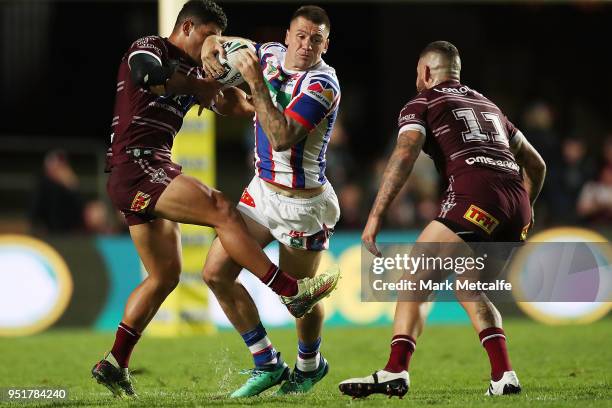 Shaun Kenny-Dowall of the Knights is tackled during the Round eight NRL match between the Manly-Warringah Sea Eagles and the Newcastle Knights at...