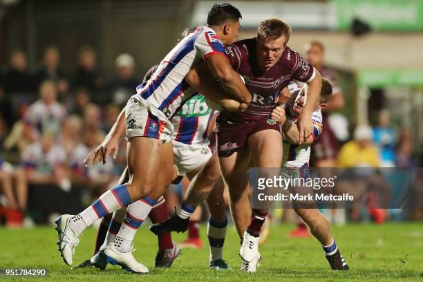 Jake Trbojevic of the Sea Eagles is tackled during the Round eight NRL match between the Manly-Warringah Sea Eagles and the Newcastle Knights at...