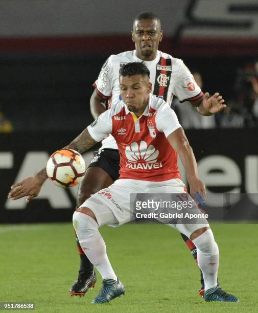 Wilson Morelo of Santa Fe vies for the ball with Juan of Flamengo during a match between Independiente Santa Fe and Flamengo as part of Copa CONMEBOL...