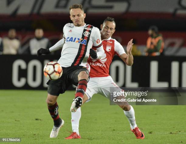 Yeison Gordillo of Santa Fe vies for the ball with Rene of Flamengo during a match between Independiente Santa Fe and Flamengo as part of Copa...