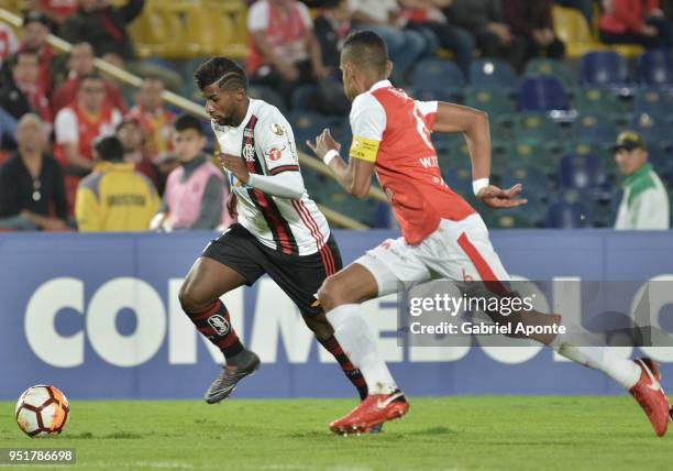 William Tesillo of Santa Fe vies for the ball with Rodnei of Flamengo during a match between Independiente Santa Fe and Flamengo as part of Copa...