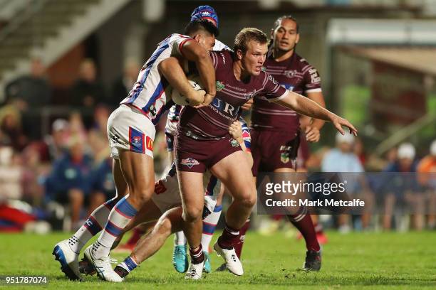 Jake Trbojevic of the Sea Eagles is tackled during the Round eight NRL match between the Manly-Warringah Sea Eagles and the Newcastle Knights at...