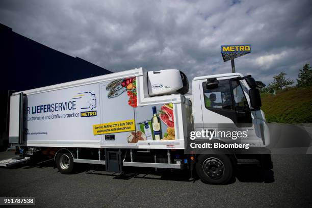 Metro AG logo sits on a sign beyond a delivery truck outside the company's wholesale food distribution depot in Weiterstadt, Germany, on Wednesday,...