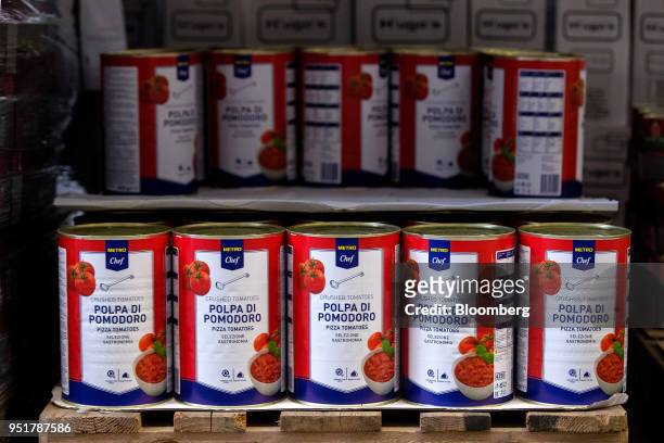 Tins of crushed tomatoes sit on a crate inside a Metro AG wholesale food distribution depot in Weiterstadt, Germany, on Wednesday, April 25, 2018....