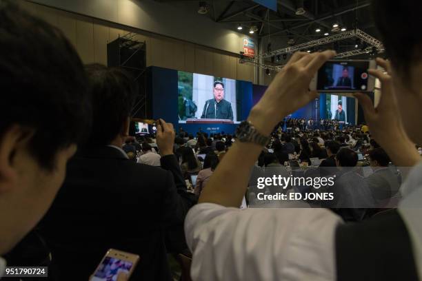 Screen shows coverage of a statement being read by North Korean leader Kim Jong Un, at the Inter-Korean Summit media centre in Goyang on April 27,...