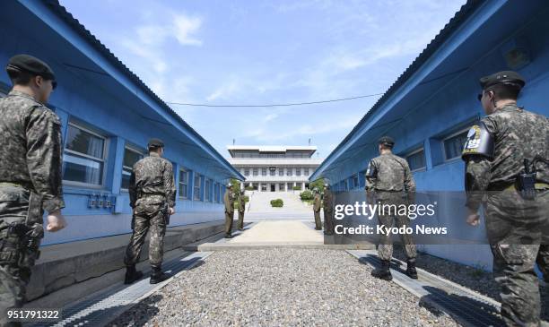 Military personnel stand guard at the border village of Panmunjeom in the Demilitarized Zone on April 26 a day before the first inter-Korean summit...