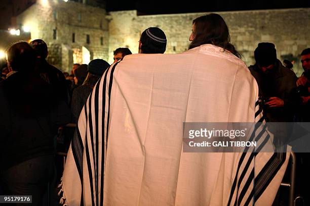 Young couple, members of Israel's Progressive Judaism movement, wrap themselves in a traditional Jewish prayer shawl for men, during a...