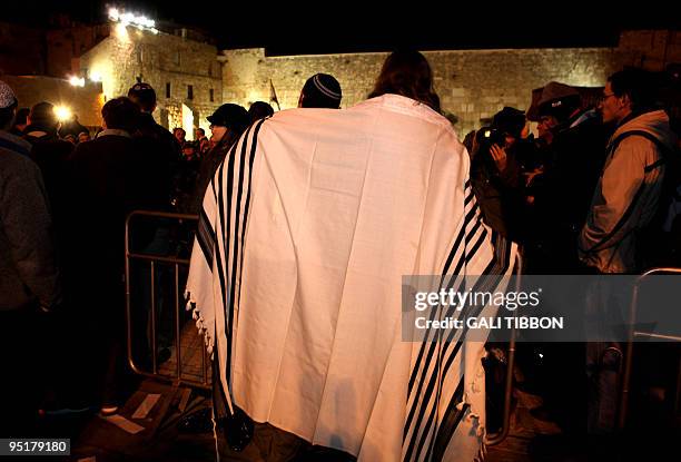 Young couple, members of Israel's Progressive Judaism movement, wrap themselves in a traditional Jewish prayer shawl for men, during a...