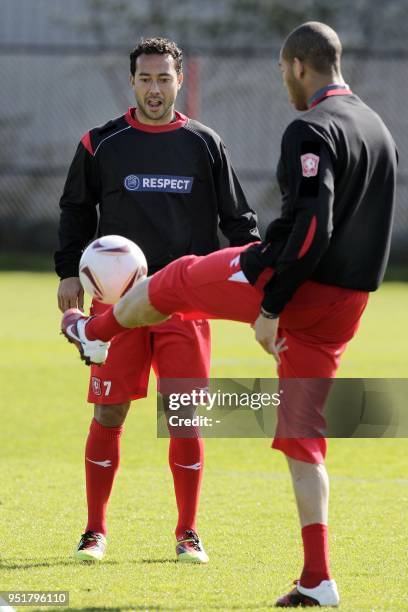 Twente's Danny Landzaat and Oguchi Onyewu take part in a training session in Enschede on April 13 a day before their UEFA Europa League football...