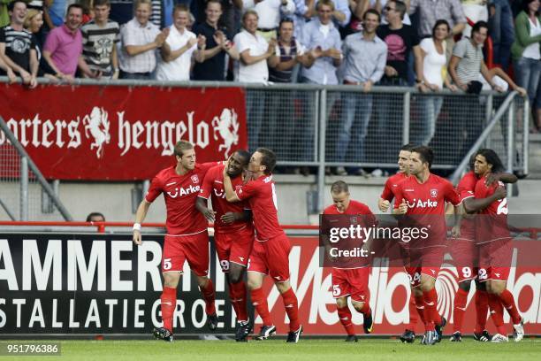 Twente players Wout Brama and Miroslav Stoch congratulate teammate Douglas as others look on after scoring 1-0 in the duel against Sporting Lisbon...