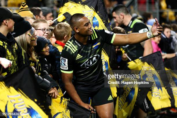 Julian Savea of the Hurricanes takes a selfie with a fan during the round 11 Super Rugby match between the Hurricanes and Sunwolves at Westpac...