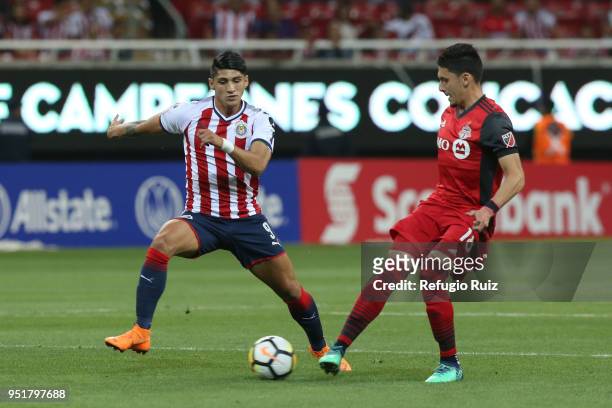 Alan Pulido of Chivas fights for the ball with Marky Delgado of Toronto FC during the second leg match of the final between Chivas and Toronto FC as...