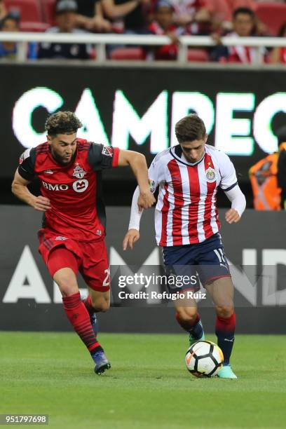 Isaac Brizuela of Chivas fights for the ball with Jonathan Osorio of Toronto FC during the second leg match of the final between Chivas and Toronto...