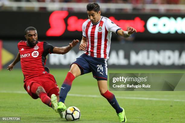 Angel Zaldivar of Chivas fights for the ball with Ashton Morgan Toronto FC during the second leg match of the final between Chivas and Toronto FC as...