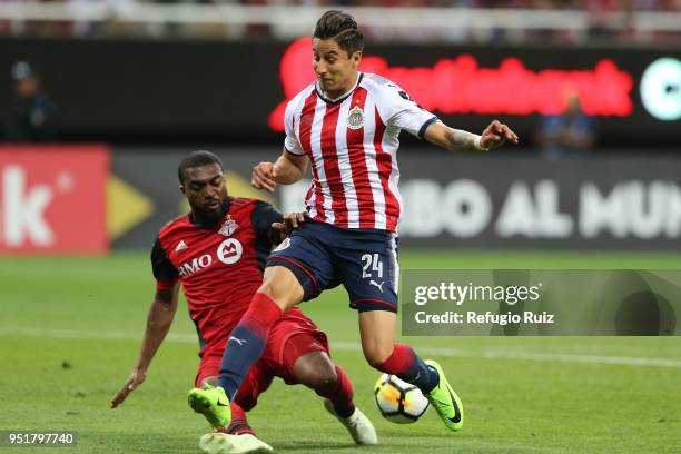 Angel Zaldivar of Chivas fights for the ball with Ashton Morgan Toronto FC during the second leg match of the final between Chivas and Toronto FC as...