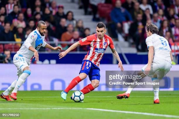 Angel Correa of Atletico de Madrid fights for the ball with Sidnei Rechel da Silva Junior of Deportivo La Coruna and Thomas Teye Partey of Atletico...