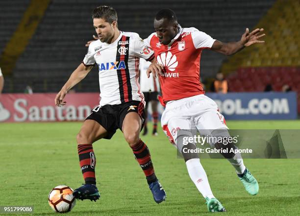 Baldomero Perlaza of Santa Fe vies for the ball with Diego Alves of Flamengo during a match between Independiente Santa Fe and Flamengo as part of...