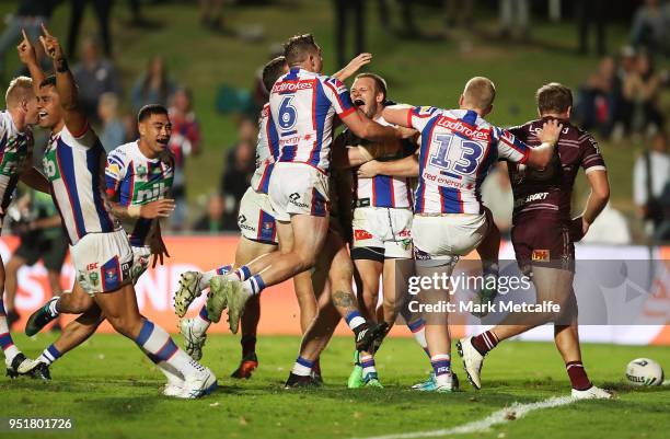 Nathan Ross of the Knights celebrates scoring a try with team mates during the Round eight NRL match between the Manly-Warringah Sea Eagles and the...
