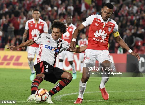 William Tesillo of Santa Fe vies for the ball with Willian Arao of Flamengo during a match between Independiente Santa Fe and Flamengo as part of...