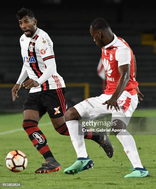 Baldomero Perlaza of Santa Fe vies for the ball with Rodnei of Flamengo during a match between Independiente Santa Fe and Flamengo as part of Copa...