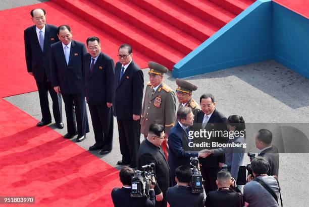 Kim Jong Un, North Korea's leader, center left, stands with Moon Jae-in, South Korea's president, as he shakes hands with Kim's sister Kim Yo Jong...