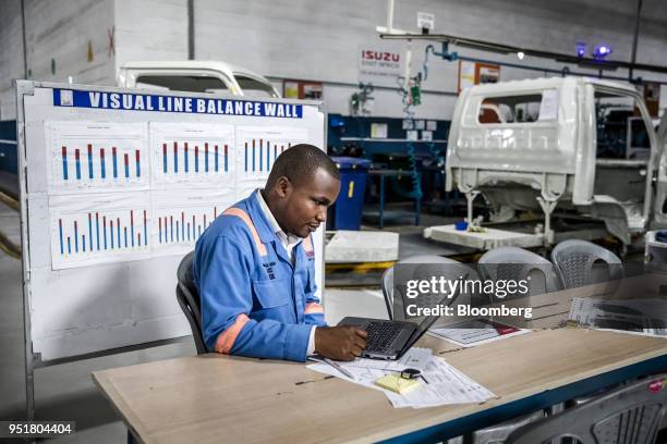 An employee works on a laptop computer inside the Isuzu East Africa Ltd. Plant in Nairobi, Kenya, on Thursday, April 26, 2018. One-ton single-cab...