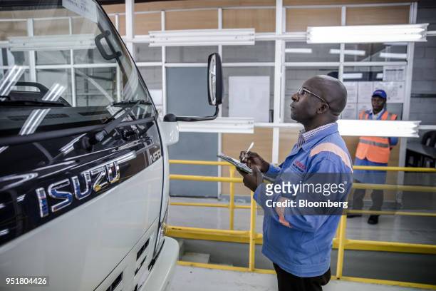 An employee checks an Isuzu NPR N-Series truck on the quality control line inside the Isuzu East Africa Ltd. Plant in Nairobi, Kenya, on Thursday,...