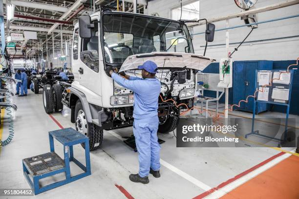 An employee works on the cabin of an Isuzu FSR 33H F-Series truck on the assembly line inside the Isuzu East Africa Ltd. Plant in Nairobi, Kenya, on...