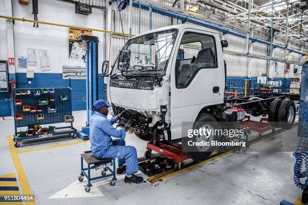 An employee works on the cabin of an Isuzu NKR N-Series truck on the assembly line inside the Isuzu East Africa Ltd. Plant in Nairobi, Kenya, on...