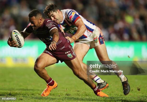 Apisai Koroisau of the Sea Eagles is tackled by Aidan Guerra of the Knights during the Round eight NRL match between the Manly-Warringah Sea Eagles...