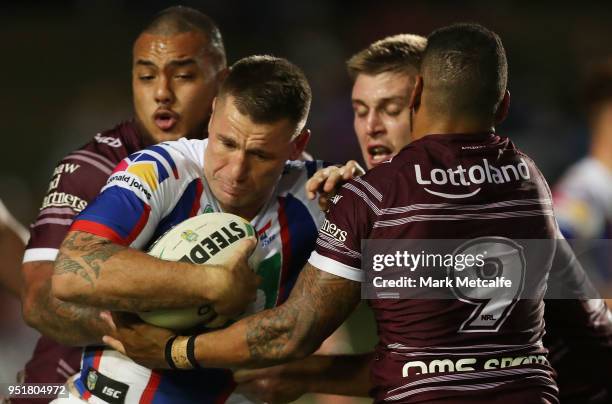 Shaun Kenny-Dowall of the Knights is tackled during the Round eight NRL match between the Manly-Warringah Sea Eagles and the Newcastle Knights at...