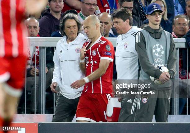 Injured, Arjen Robben of Bayern Munich leaves the pitch with Doctor of Bayern Munich Hans-Wilhelm Muller-Wohlfahrt during the UEFA Champions League...