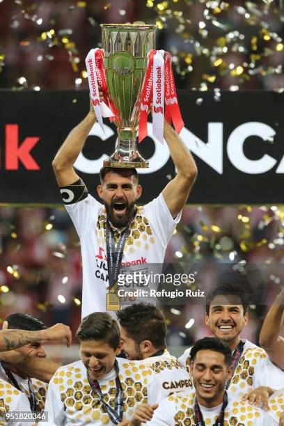 Juan Basulto of Chivas holds up the trophy after winning the second leg match of the final between Chivas and Toronto FC as part of CONCACAF...