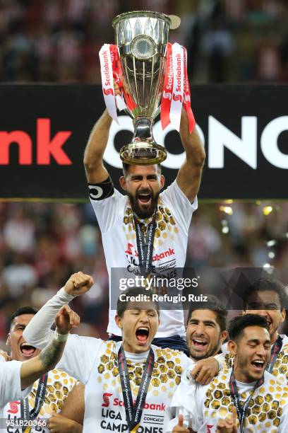 Juan Basulto of Chivas holds up the trophy after winning the second leg match of the final between Chivas and Toronto FC as part of CONCACAF...