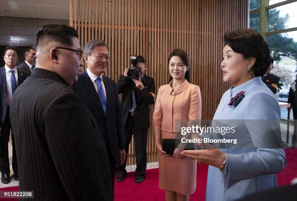Kim Jung-sook, South Korea's first lady, right, speaks with Kim Jong Un, North Korea's leader, left, as Moon Jae-in, South Korea's president, second...