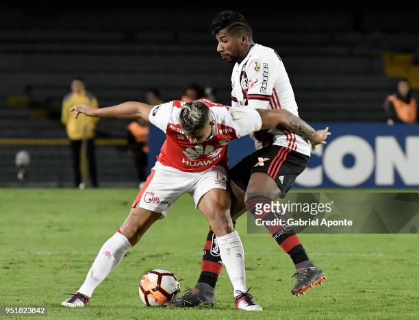 Juan Daniel Roa of Santa Fe vies for the ball with Rodnei of Flamengo during a match between Independiente Santa Fe and Flamengo as part of Copa...