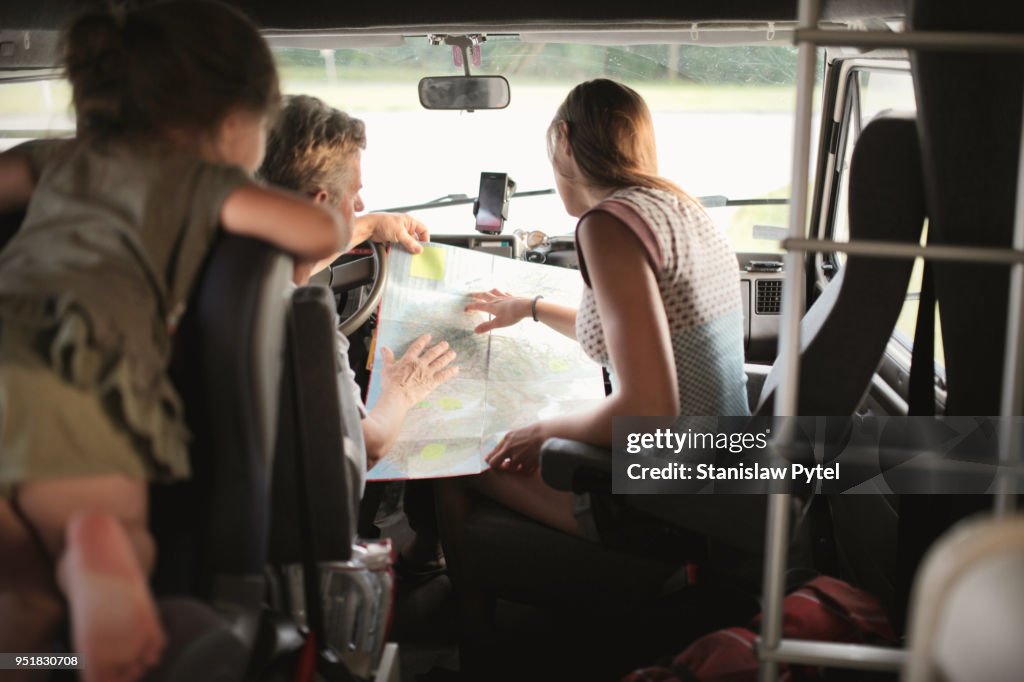 Family reading map in campervan