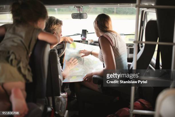Family reading map in campervan