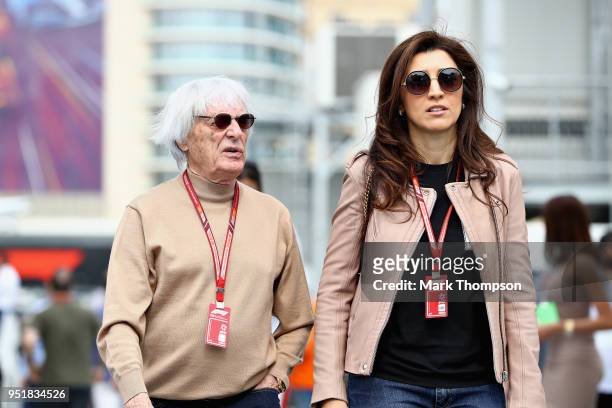 Bernie Ecclestone, Chairman Emeritus of the Formula One Group, walks with his wife Fabiana Ecclestone in the Paddock during practice for the...