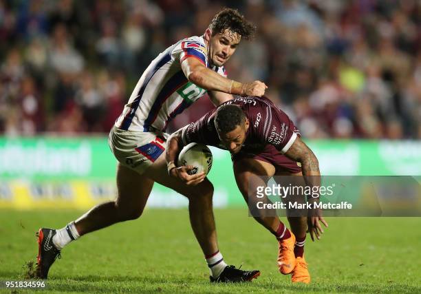 Apisai Koroisau of the Sea Eagles is tackled by Aidan Guerra of the Knights during the Round eight NRL match between the Manly-Warringah Sea Eagles...