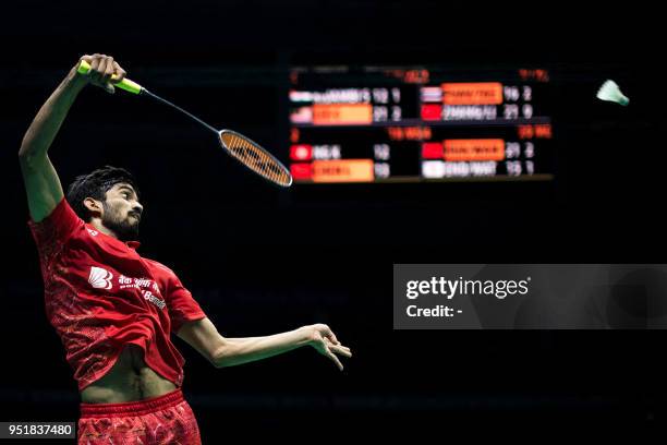 Kidambi Srikanth of India hits a return against Lee Chong Wei of Malaysia during their men's singles quarter-finals match at the 2018 Badminton Asia...