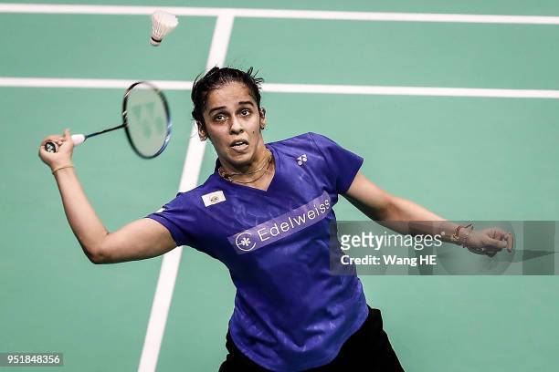Saina Nehwal of India hits a return during their women's singles match against Lee Jang mi of Korea at the 2018 Badminton Asia Championships on Apirl...