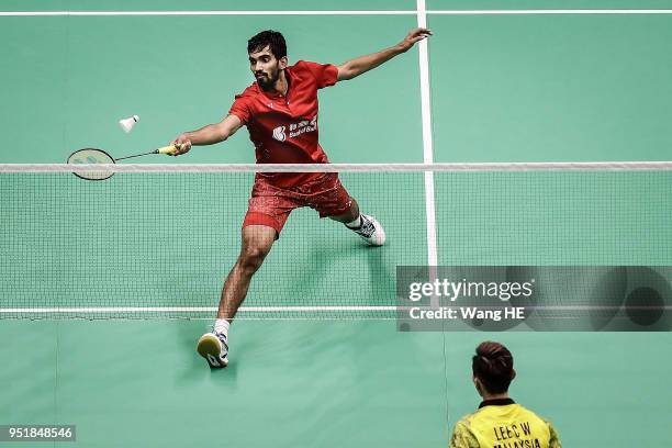 Kidambi Srikanth of India hits a return during man's singles match against Lee Chong Wei of Malaysia at the 2018 Badminton Asia Championships on...