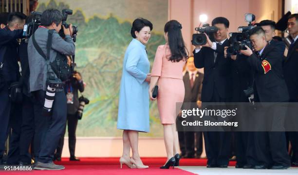 Kim Jung-sook, South Korea's first lady, center left, greets Ri Sol Ju, North Korea's first lady, center right, ahead of a banquet during the...