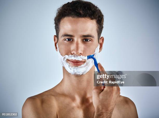 handsome young man with lathered face prepares to shave - man shaving foam stock pictures, royalty-free photos & images