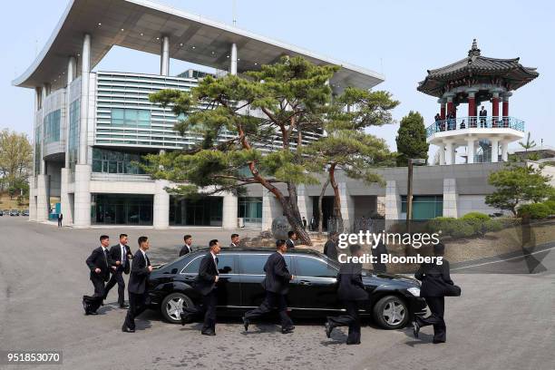 North Korean security escort a vehicle carrying Kim Jong Un, North Korea's leader, following the morning session of the inter-Korean summit in the...